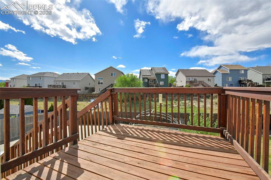 Image 29 of 46: Wood deck off the kitchen with lovely views