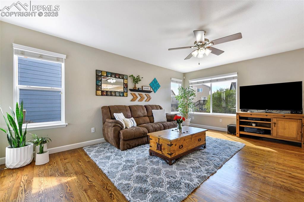 Image 4 of 46: Bright living area featuring hard wood floors and lots of natural light 