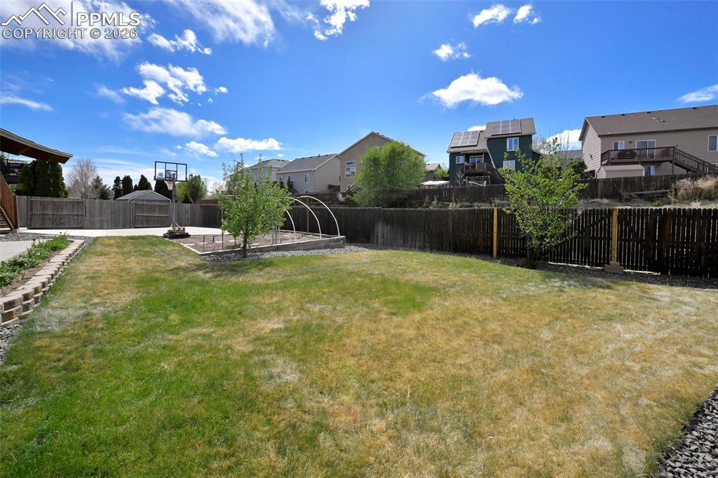 Image 40 of 46: Generous grassy yard ideal for outdoor living