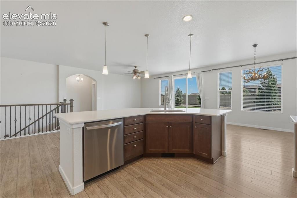 Image 11 of 50: Contemporary kitchen island featuring a stainless steel dishwasher, undermo