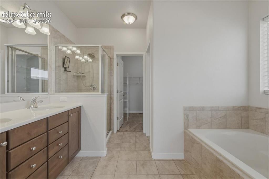 Image 22 of 50: Bright room with multiple windows, including a high transom window, neutral