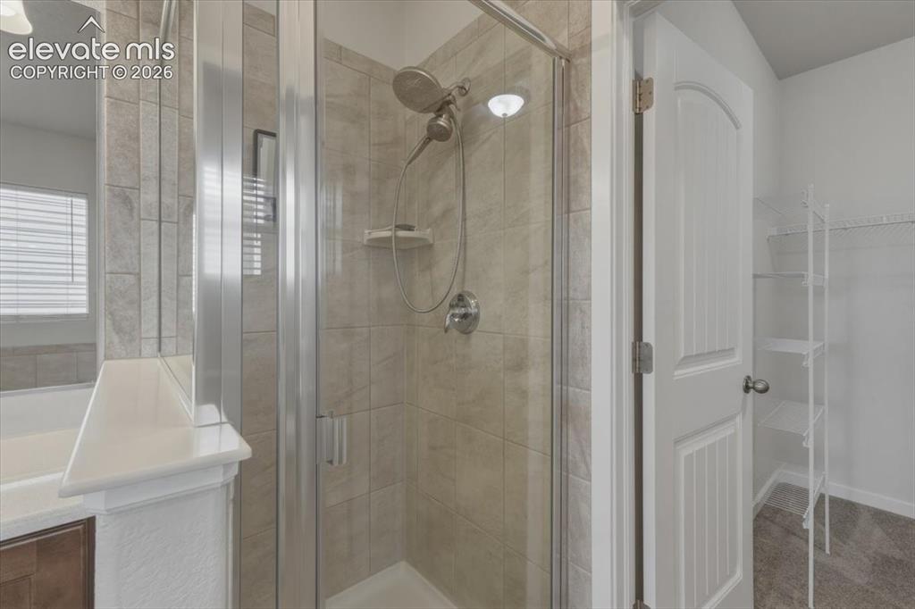 Image 25 of 50: Spacious room featuring neutral carpeting, a multi-pane window with blinds,