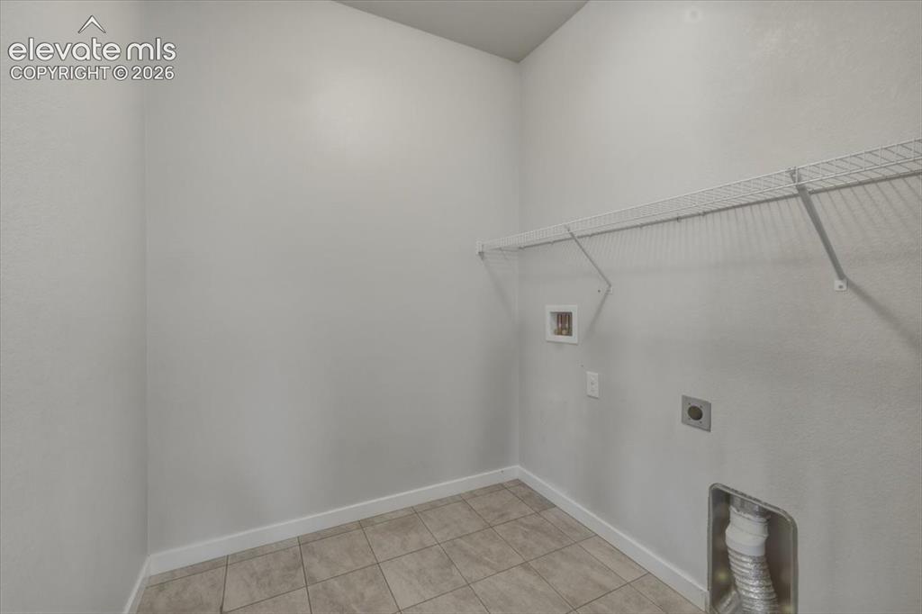 Image 27 of 50: Bathroom featuring a dual vanity with wood-finish cabinetry and light count