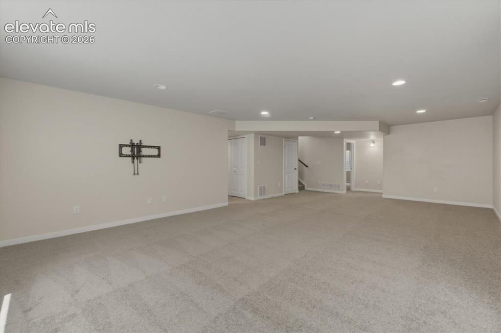 Image 31 of 50: Utility space with tile flooring and built in shelves.