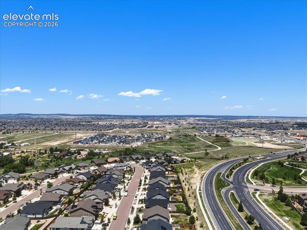 Image 50 of 50: Aerial perspective showcasing multiple properties with distant mountain sce