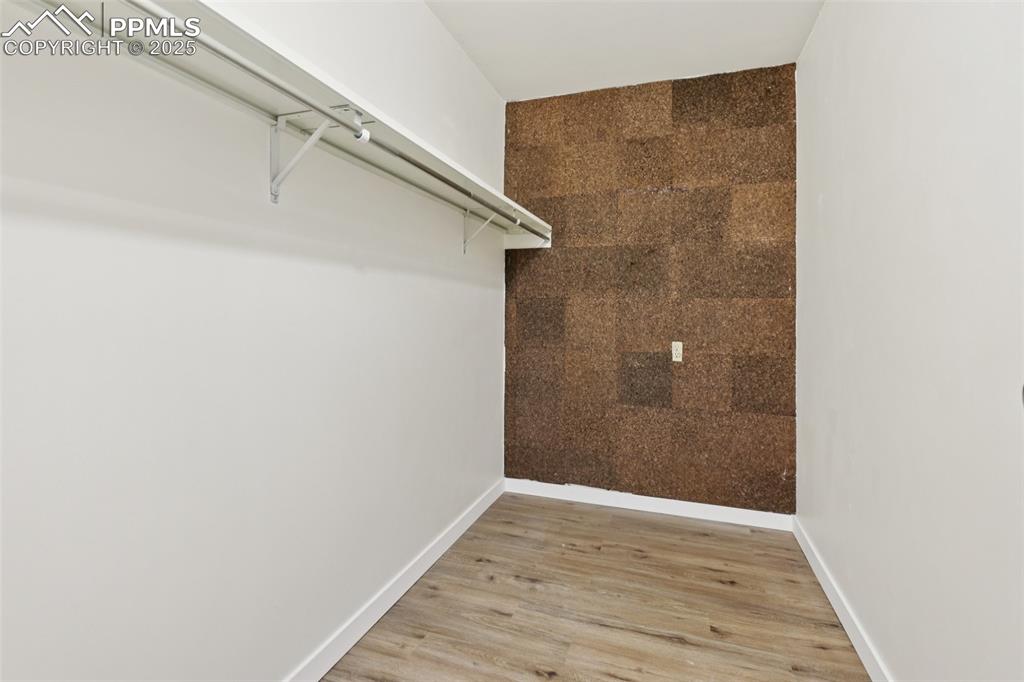 Image 12 of 25: Walk in closet featuring light wood-type flooring