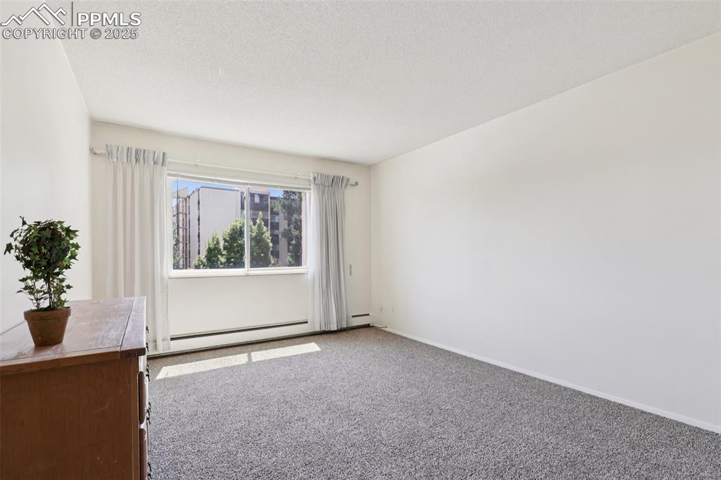 Image 14 of 25: Carpeted spare room with baseboards