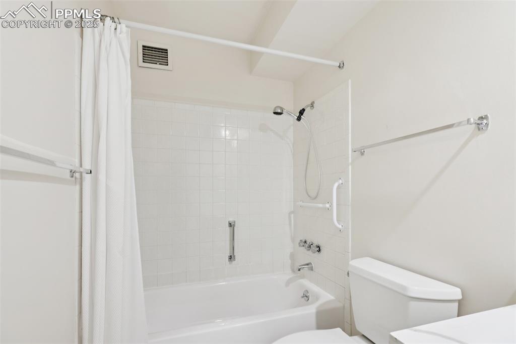 Image 20 of 25: Bathroom featuring shower / bath combo and vanity