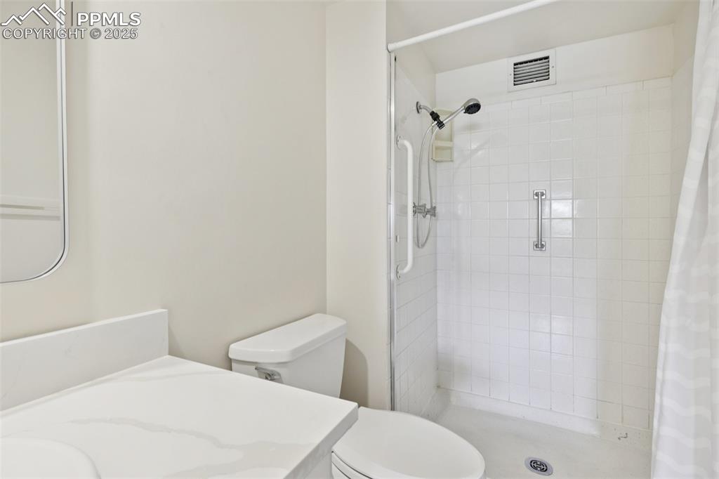 Image 21 of 25: Bathroom with vanity and a tile shower