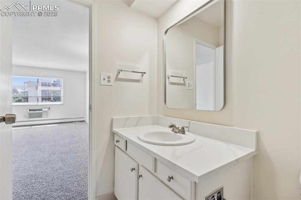 Image 22 of 25: Bathroom featuring vanity and a baseboard heating unit