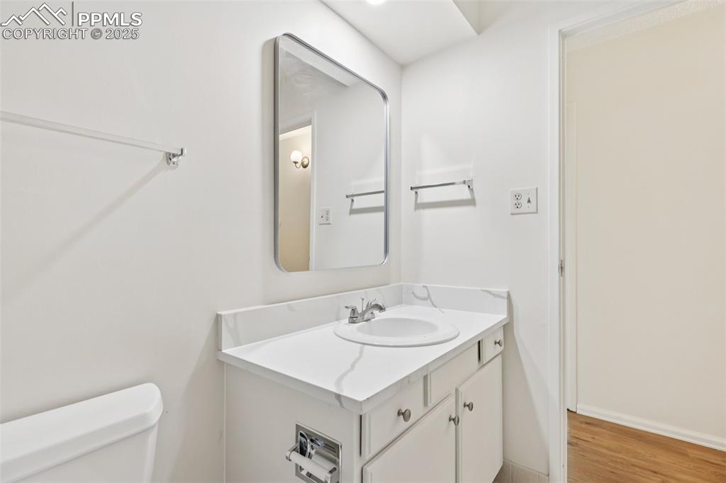 Image 23 of 25: Bathroom featuring vanity and wood finished floors