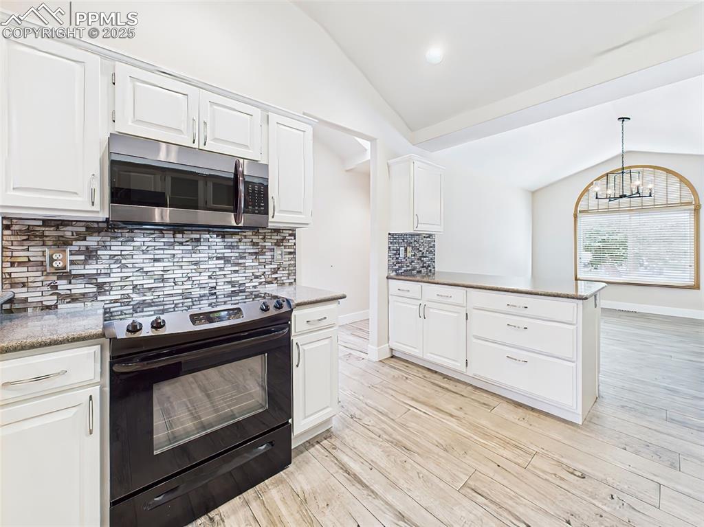 Image 15 of 50: Gorgeous corian countertops and view into dining room!