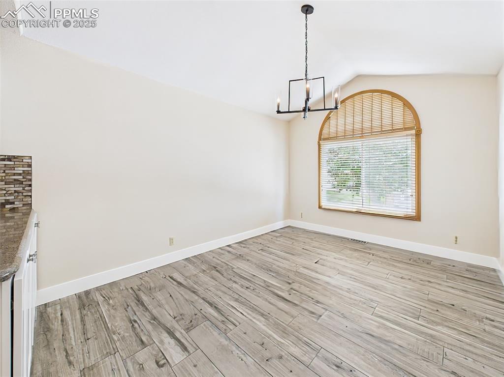 Image 17 of 50: Large Dining Room with New light fixture and large fashionable window!