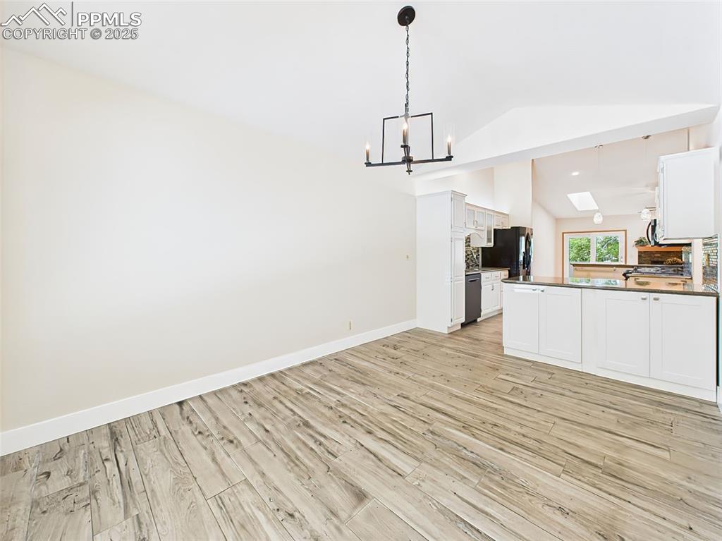 Image 19 of 50: view looking into kitchen! Also notice the cabinet storage for the dining a