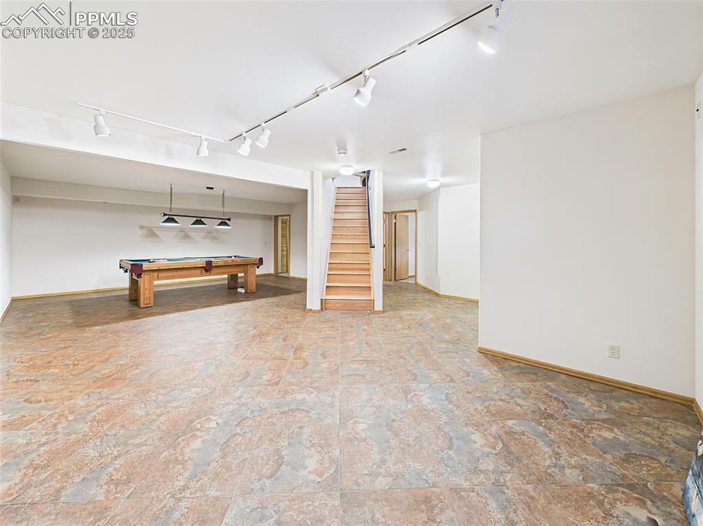 Image 32 of 50: Basement Family Room with ceramic tiled floors, track lighting and Billiard