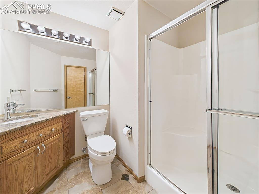 Image 39 of 50: 3/4 Bathroom in Basement has newer slab granite countertop and fixtures.