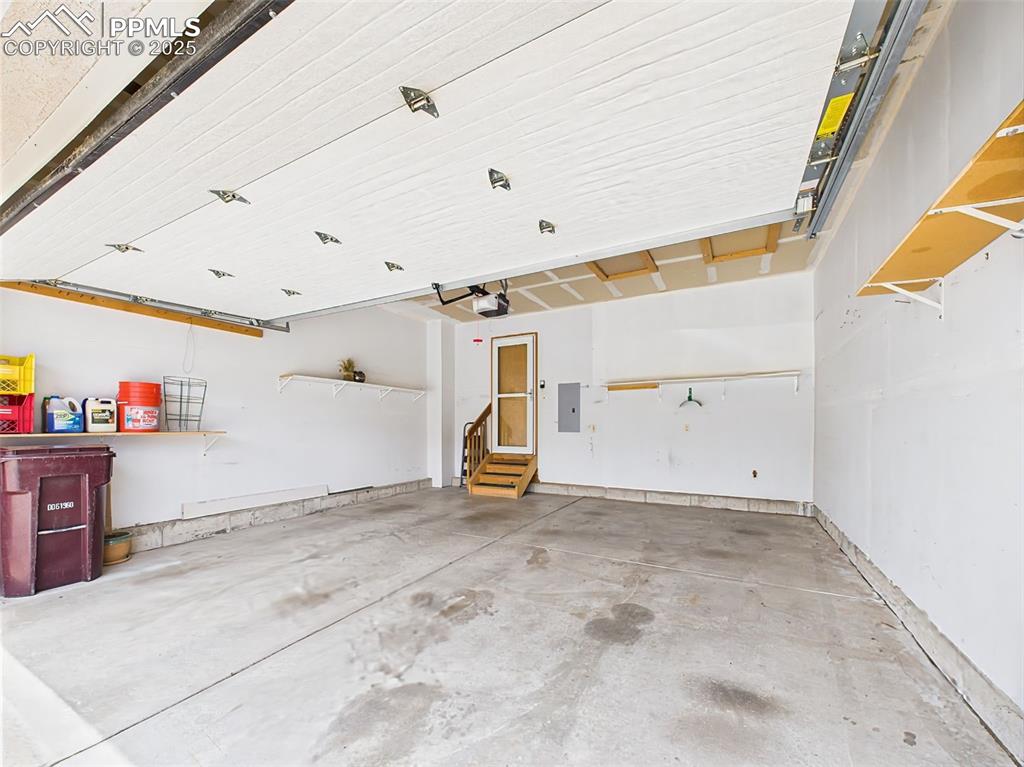 Image 44 of 50: 2-Car Finished Garage with some shelving!