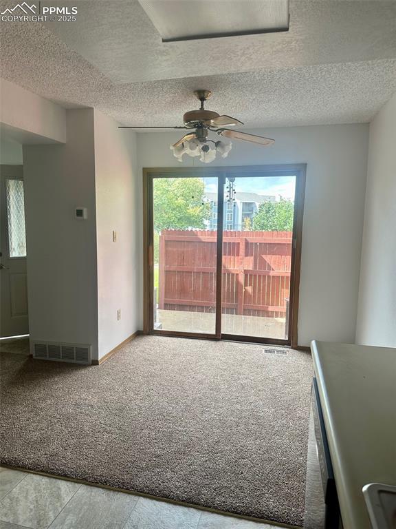 Image 13 of 39: New carpet, sliding doors lead to front patio area.