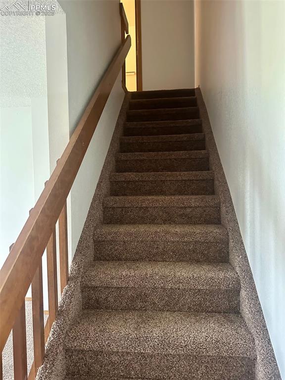 Image 16 of 39: Stairs leading to upstairs bedrooms.
