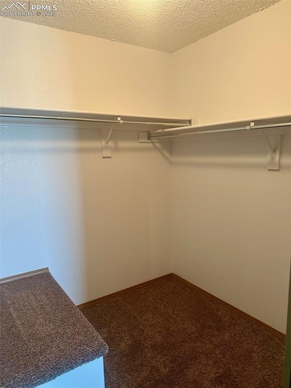 Image 20 of 39: Walk in closet in primary bedroom.