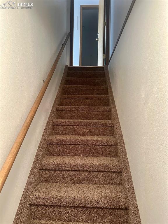 Image 25 of 39: Stairs leading to basement level.