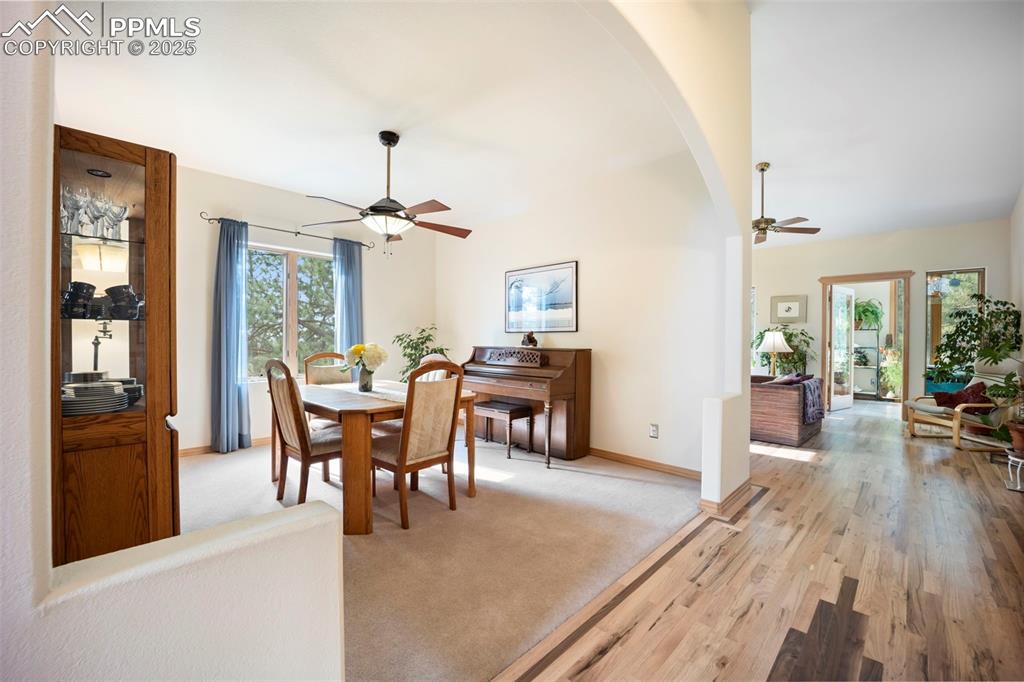Image 13 of 50: Spacious ormal Dining Room is framed by graceful arch
