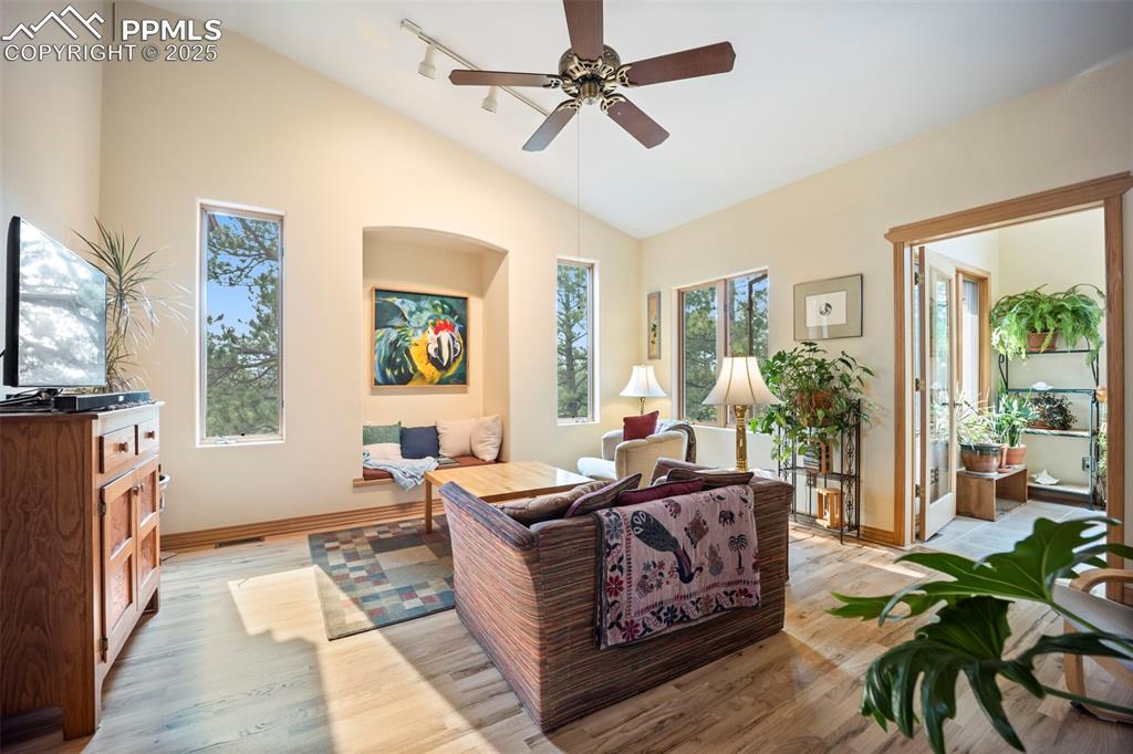 Image 8 of 50: Living Room features include hardwood floors, access to Garden Room and vau