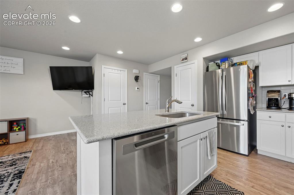 Image 2 of 30: Kitchen featuring a center island with an undermount sink, stainless steel