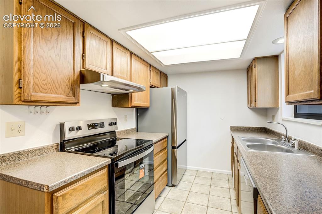 Image 18 of 50: Galley kitchen with NEW Stainless-Steel Appliances