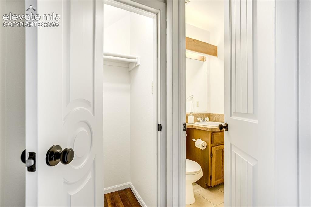 Image 27 of 50: Convenient half-bath and under stairs storage 