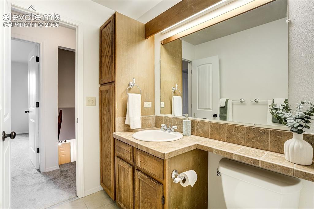 Image 36 of 50: Full upstairs bathroom with large cabinets