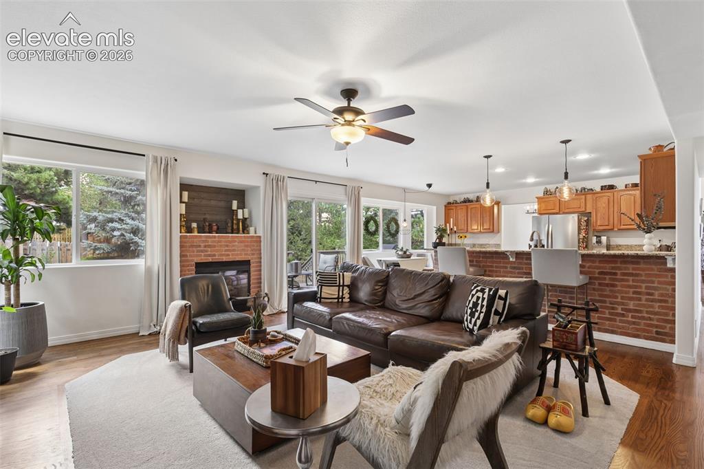 Image 14 of 27: Family room, gas fireplace and adjacent kitchen