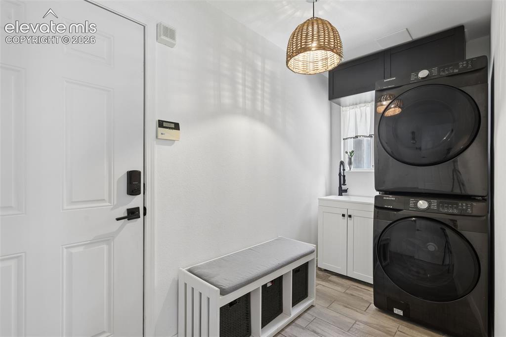 Image 15 of 27: Laundry/mud-room and entry into 3 car garage
