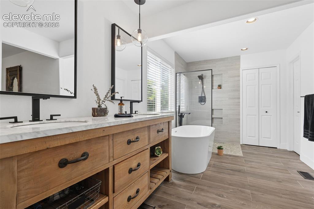 Image 20 of 27: primary bathroom with double vanities- sinks/separate  garden-soaking tub a