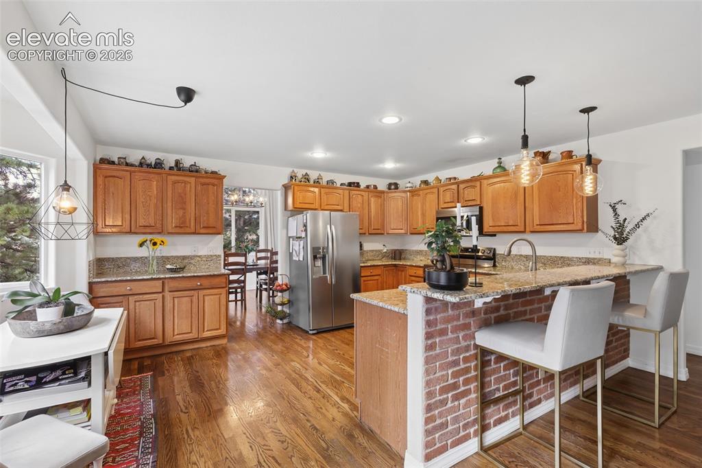 Image 6 of 27: Eat in kitchen with counter-bar top