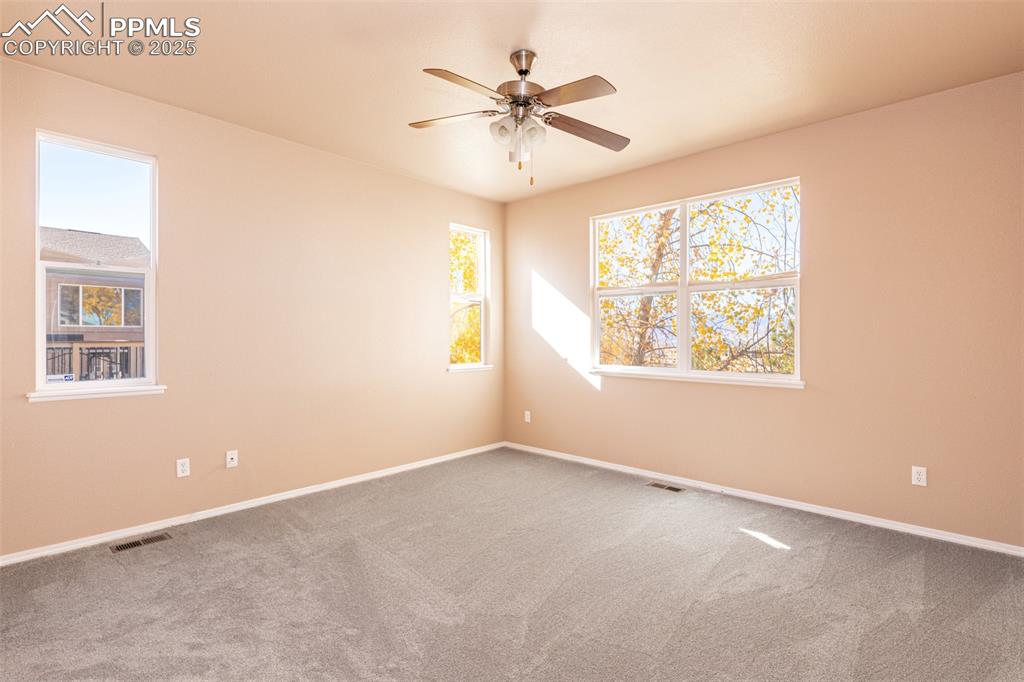 Image 14 of 41: Carpeted empty room with baseboards and a ceiling fan