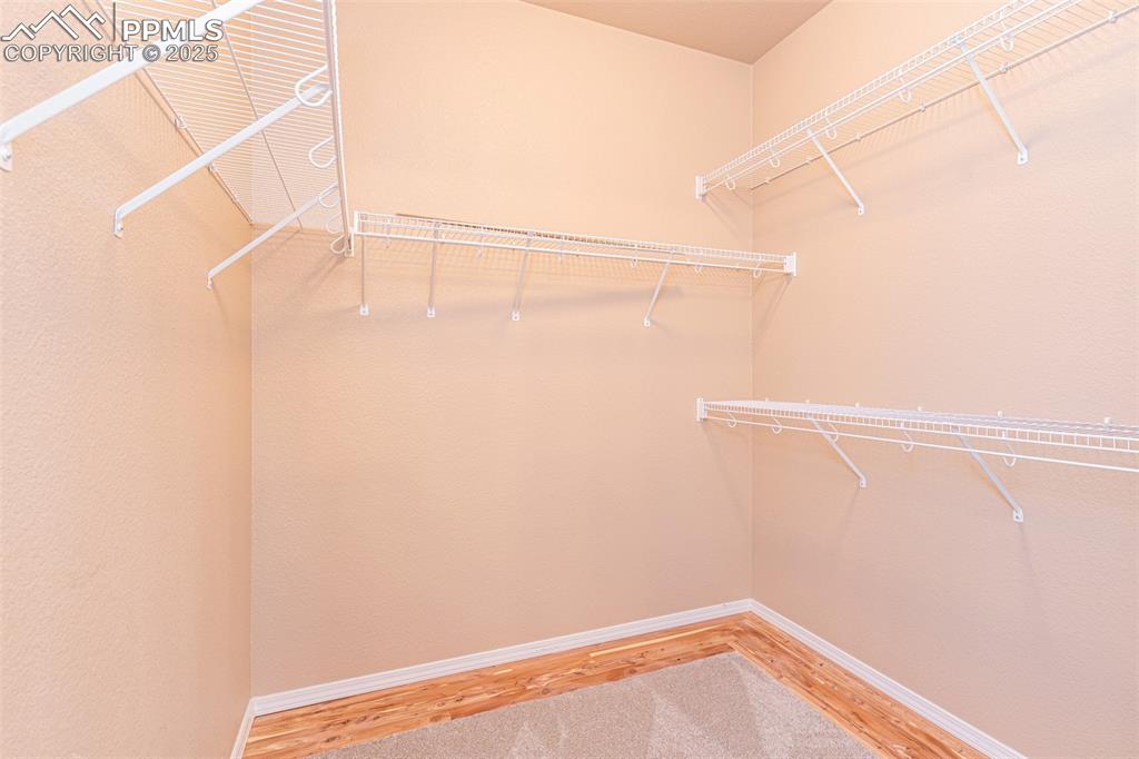 Image 18 of 41: Spacious closet with light wood-style floors