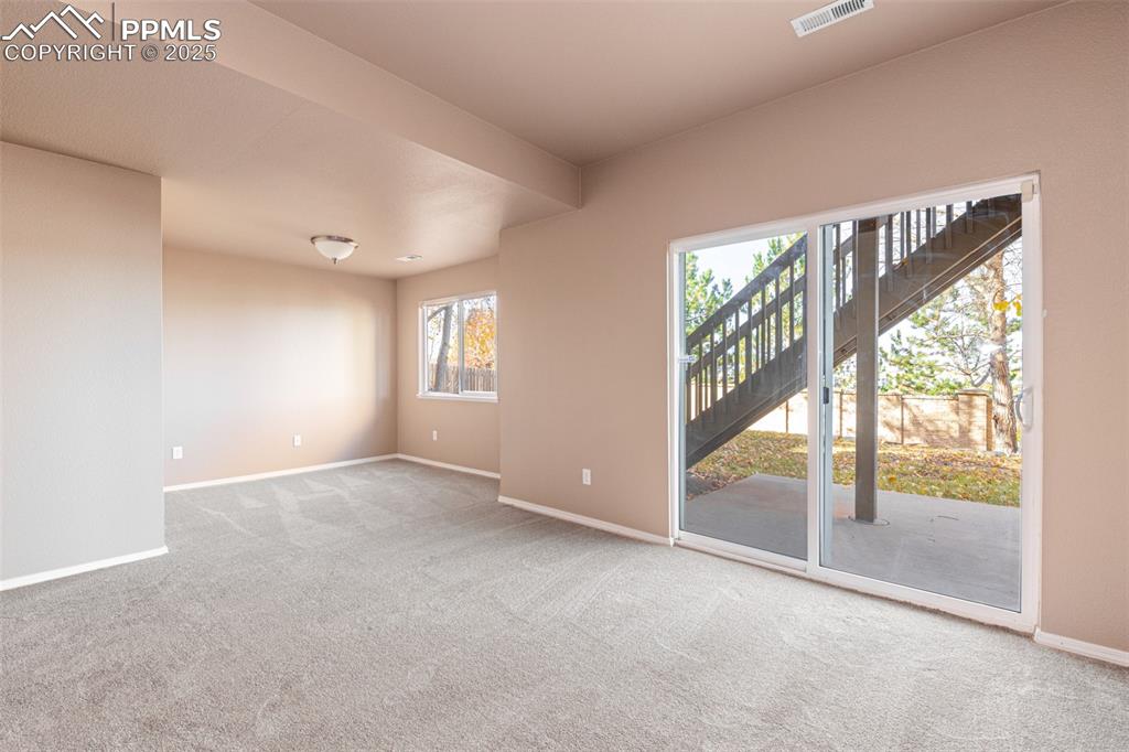 Image 22 of 41: Empty room with light colored carpet and baseboards