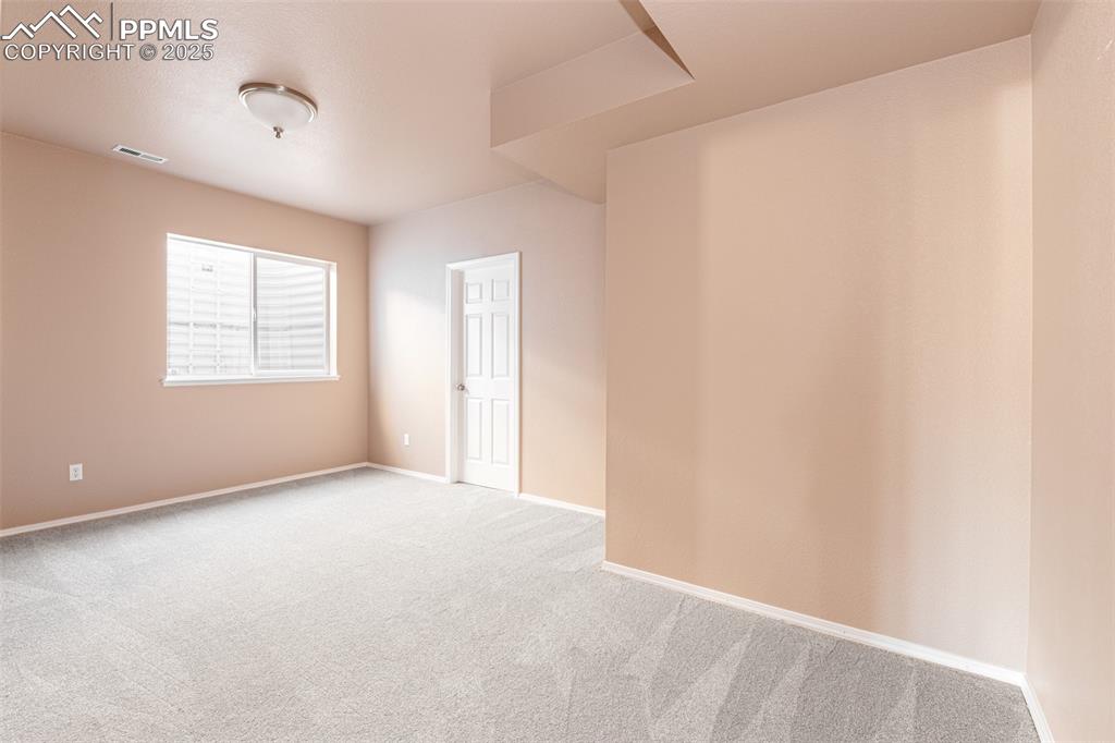 Image 23 of 41: Carpeted spare room featuring baseboards