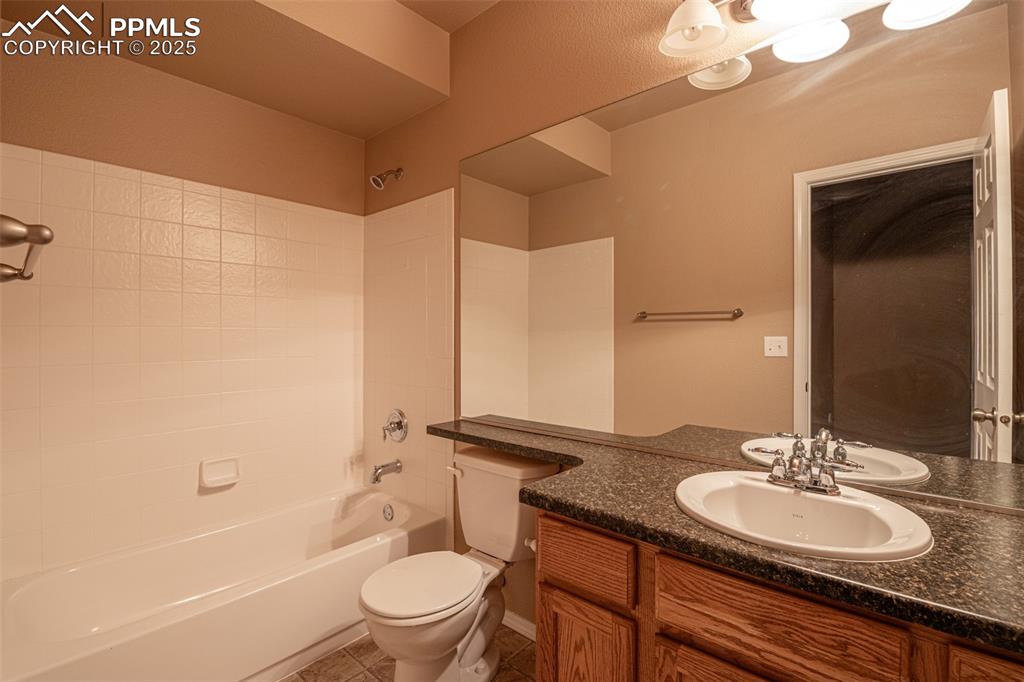 Image 27 of 41: Full bathroom featuring bathtub / shower combination, vanity, and light til