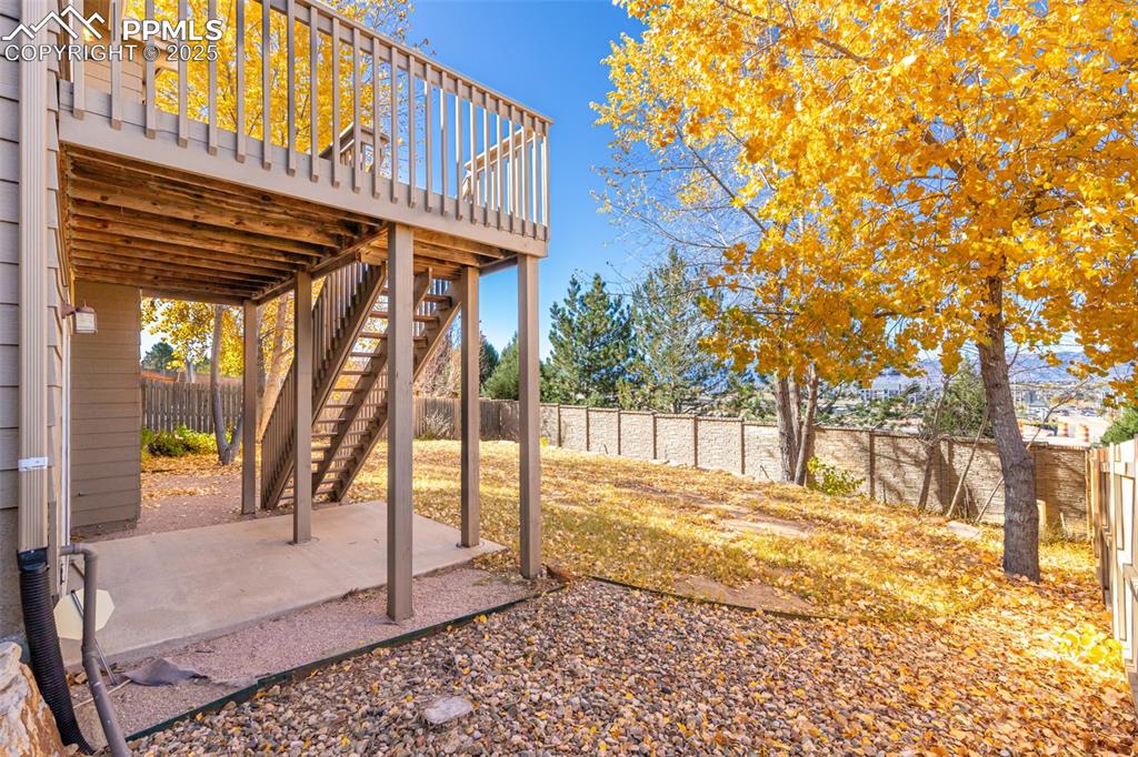 Image 33 of 41: Fenced backyard with a patio area, a deck, and stairs
