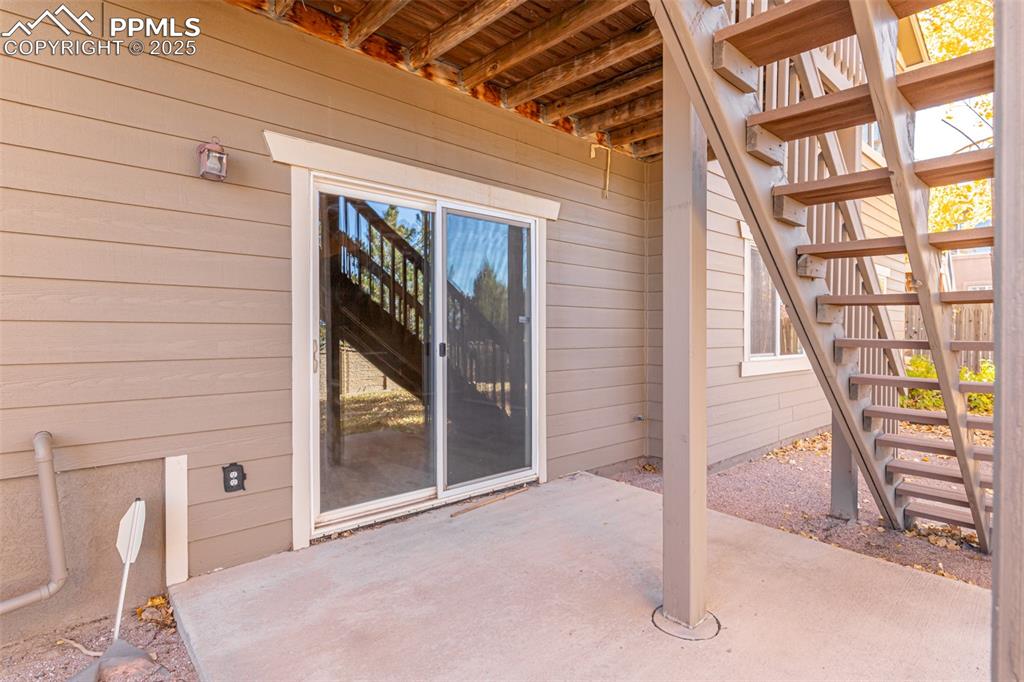 Image 38 of 41: View of exterior Walk Out entry featuring a patio