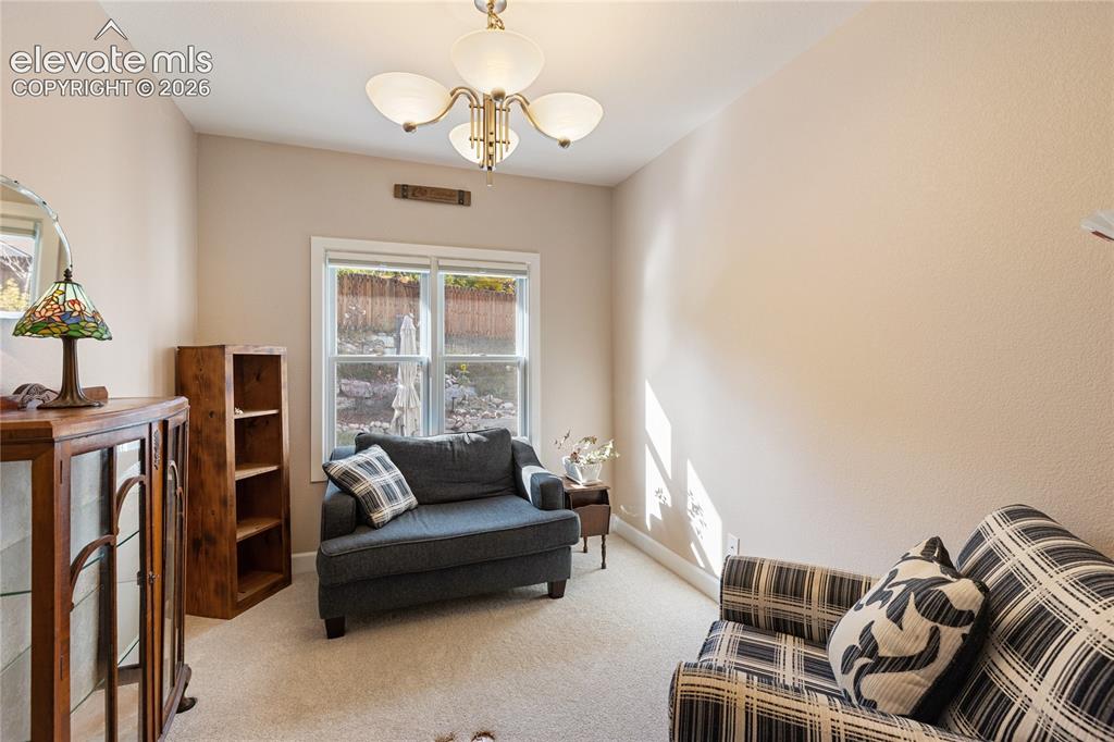 Image 14 of 38: Plush carpet flooring, neutral-toned walls, and a multi-pane window