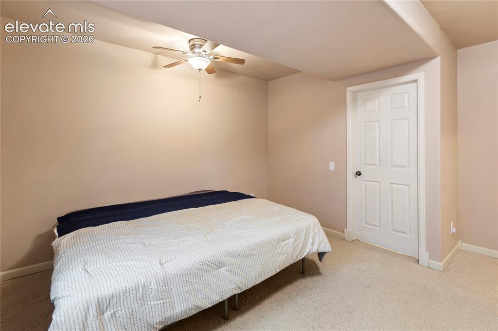 Image 27 of 38: Carpeted flooring, recessed ceiling, ceiling fan with light fixture, white