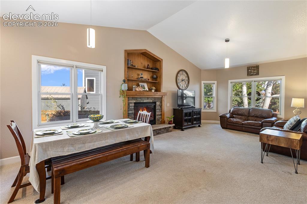 Image 30 of 38: Vaulted ceilings, stone-faced fireplace with wood mantel, built-in shelving