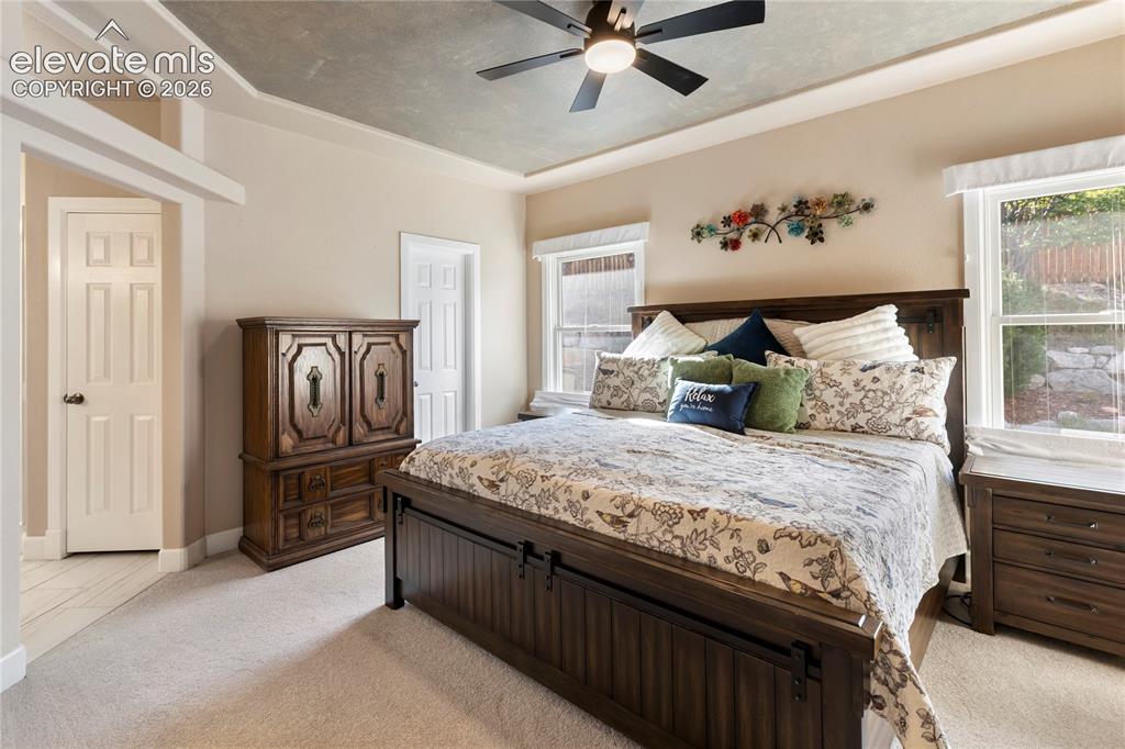 Image 6 of 38: Recessed ceiling with an overhead fan light fixture, two paneled doors, and
