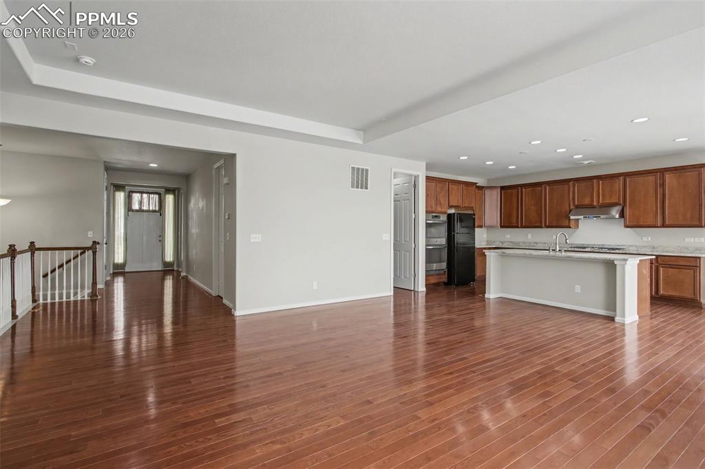 Image 13 of 40: Unfurnished living room featuring recessed lighting and dark wood finished 