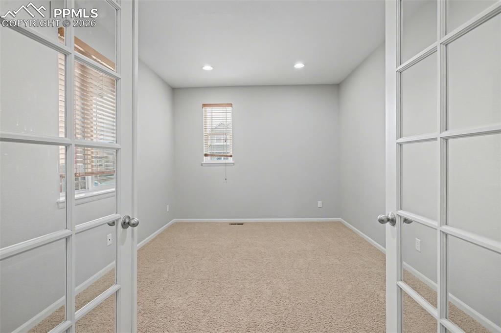 Image 17 of 40: Unfurnished room featuring light colored carpet, french doors, and recessed
