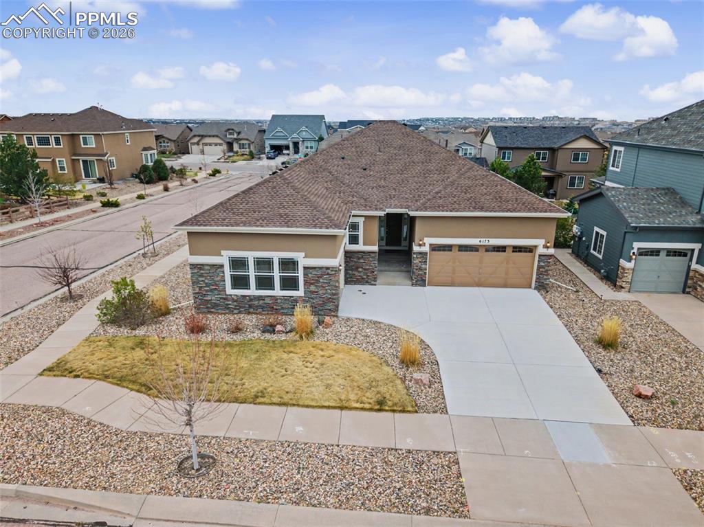 Image 2 of 40: View of front of property with stone siding, stucco siding, a residential v