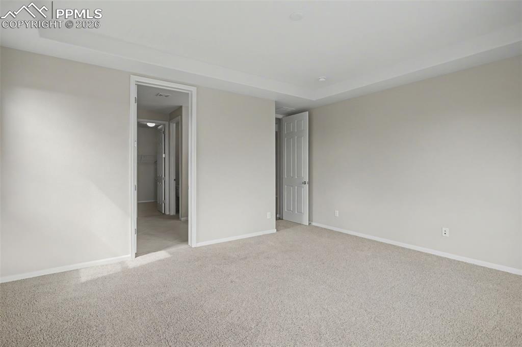 Image 21 of 40: Unfurnished bedroom with light colored carpet and baseboards